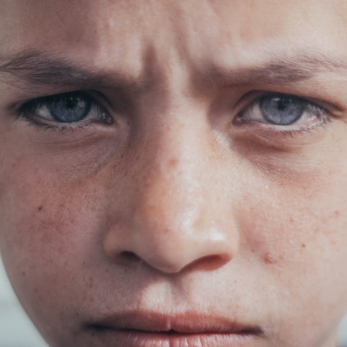 young boy with troubled eyes