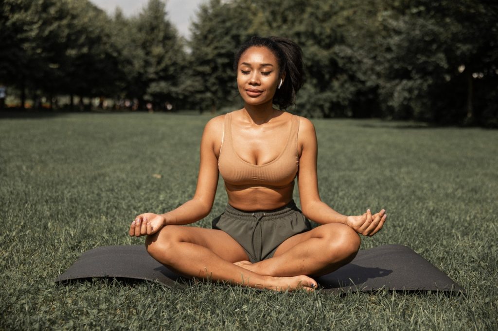 woman doing yoga in a park