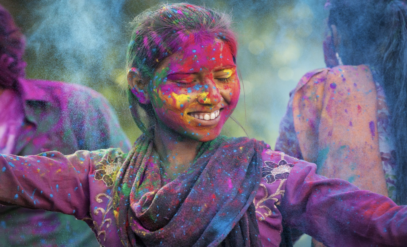 joyful person covered in color dust in celebration